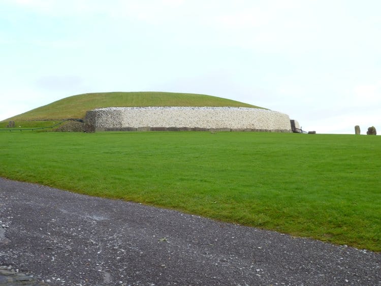 Newgrange in Accessible Ireland is a circular mound with stone sides on a grassy field