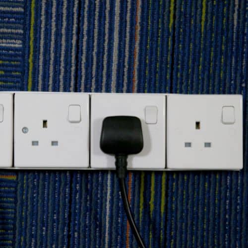 A white power strip with type g outlets as used in Ireland