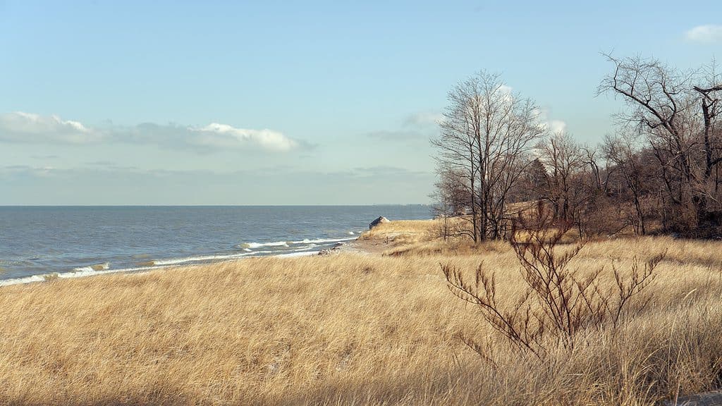 A grassy sand dune greets the shores of Lake Michigan at Indiana Sand Dunes National Park