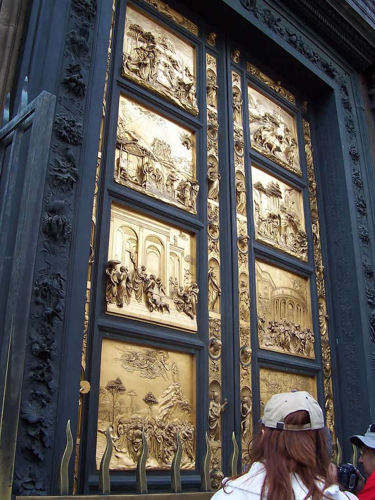 A large golden door framed by dark green iron has eight panels depicting scenes from the Bible.  Viewing this popular door is one of the wheelchair accessible things to do in Florence