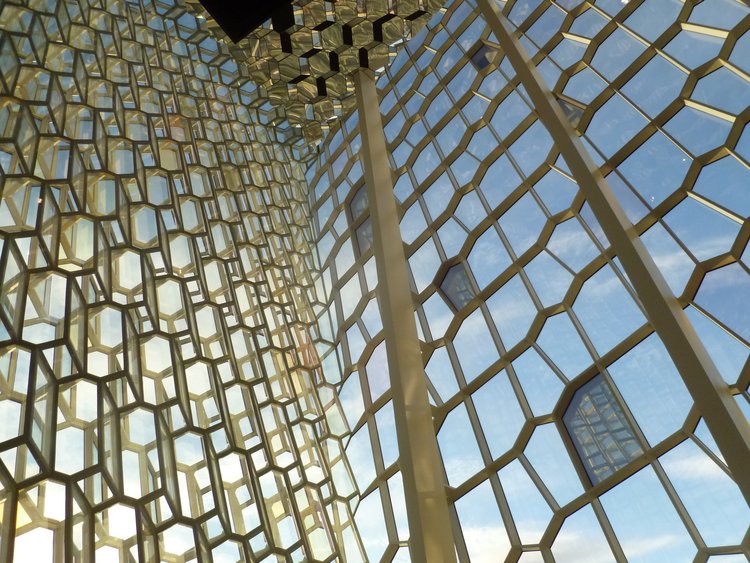 Inside the Harpa Theater looking up and out of the geometric glass that makes up the Harpa in Reykjavik Iceland