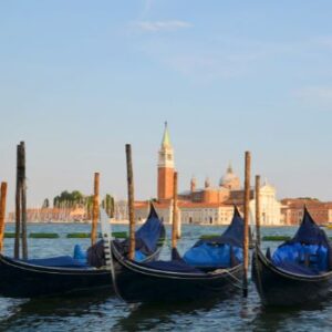 Three gondolas are lined up in the Grand Canal in Venice Italy.