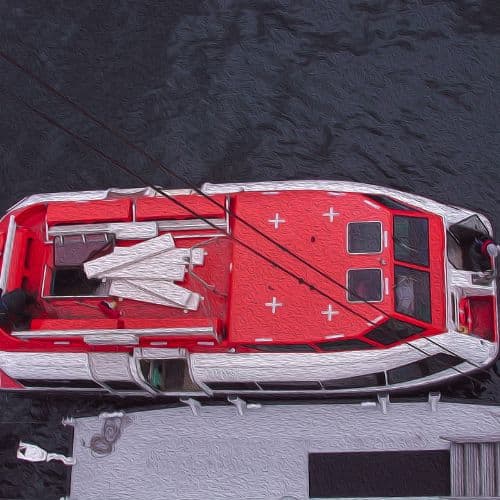 an orange and white ender boat is pulled alongside a grey floating dock.  Do your best to avoid tenders on your wheelchair accessible cruise to Europe