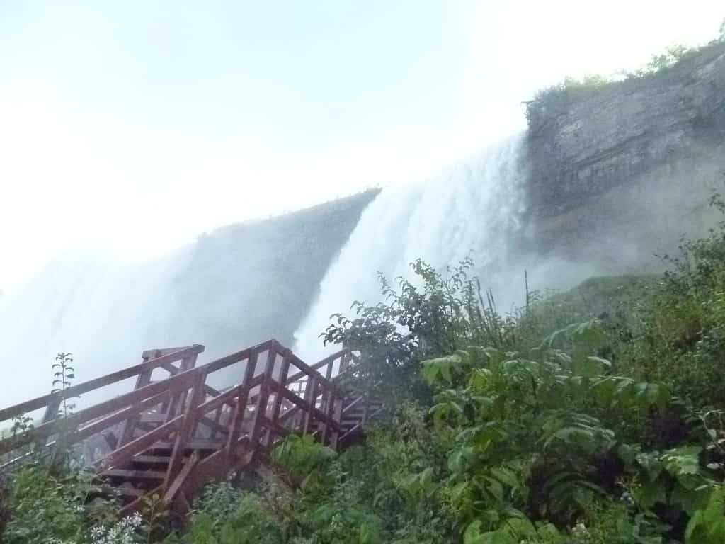 A red staircase leads to the base of Bridal Veil Falls at Cave of the Winds, making this attraction partially wheelchair accessible