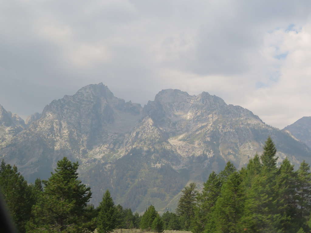 One of the mountains in the Grand Tetons with a close up view of a glacier on the side of the mountain