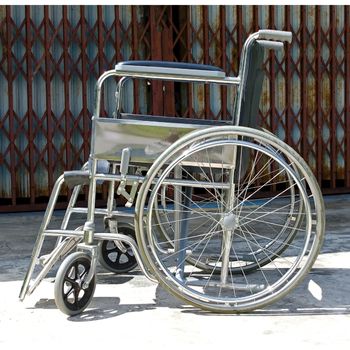 a manual wheelchair sits parallel to your view with a dark background