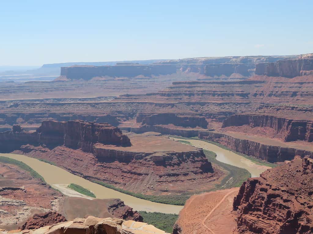 A horseshoe shaped river bends around canyon formations at Dead Horse State PArk in Utah