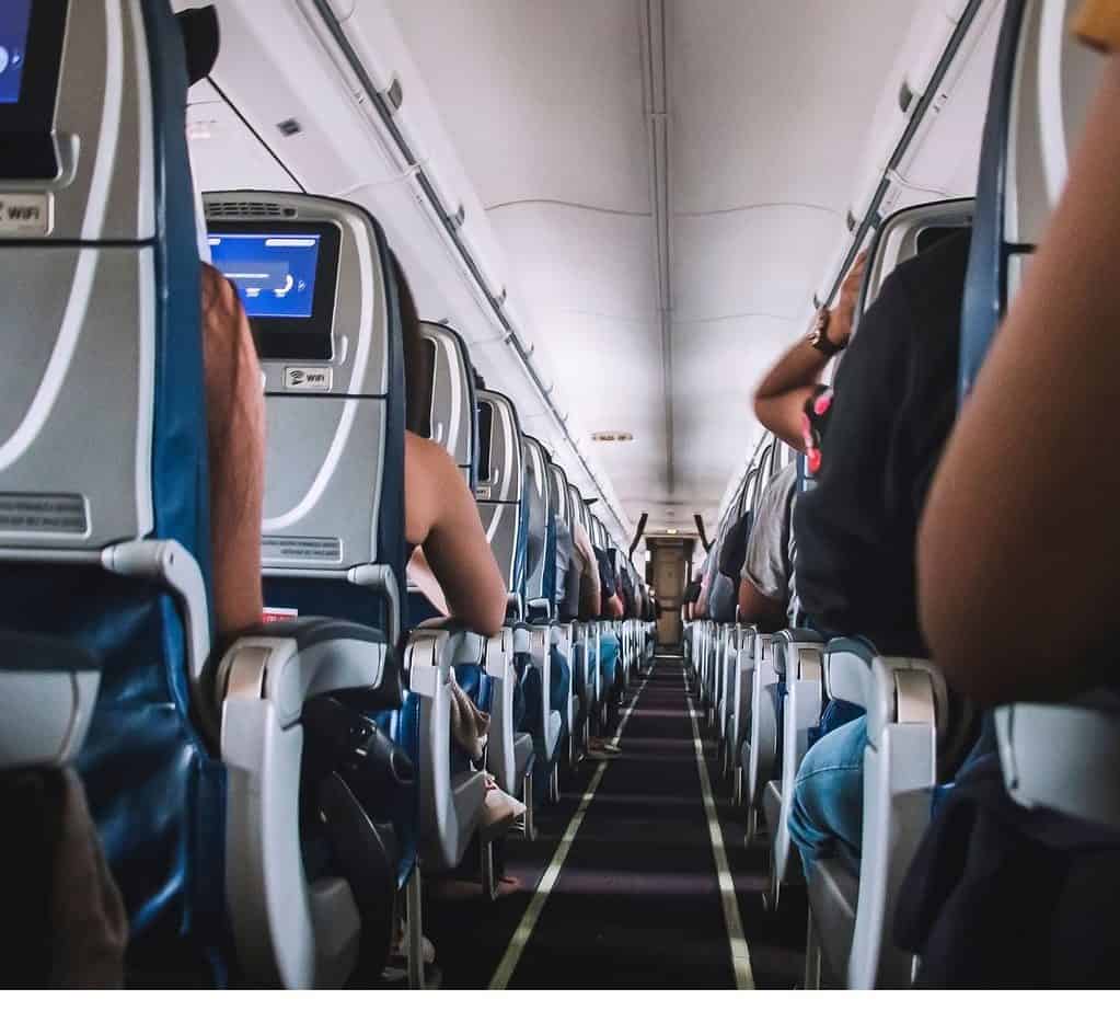 Looking down a narrow aisle of an airplane with seats on either side