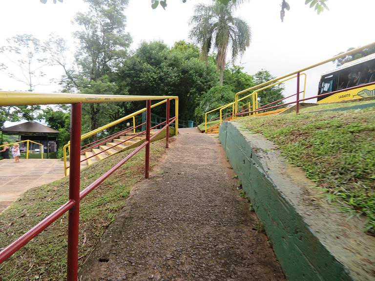 A red paved ramp way that leads to an overlook of Iguazu Falls on the Brazilian side