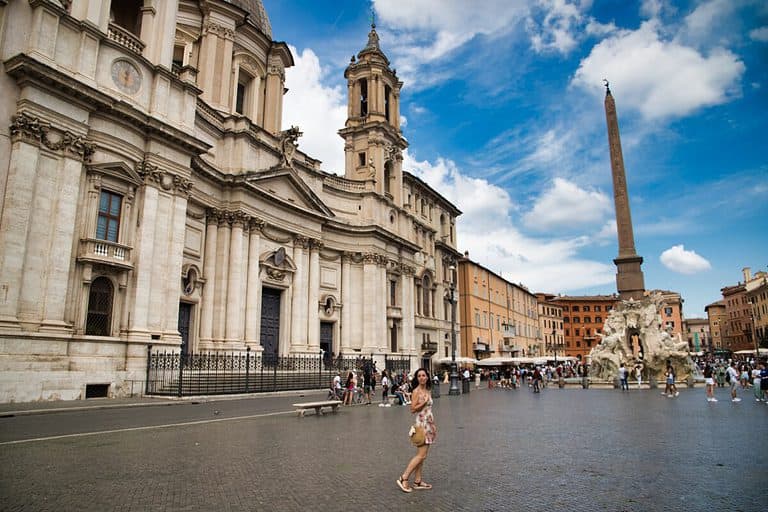 Piazza Navona in Rome Italy has a large fountain with an obelisk and colorful buildings that line the square