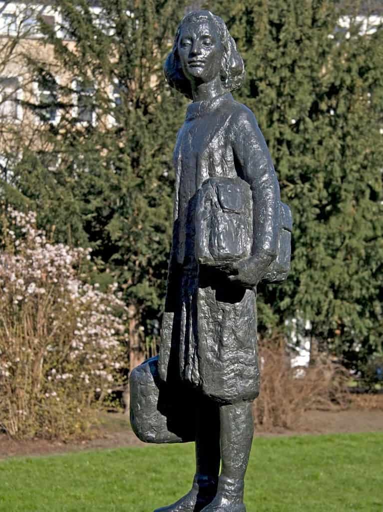 Learning about the history of the city is an Amsterdam tourist attraction and is symbolized with a black statue of Anne Frank holding a bag in Amsterdam.