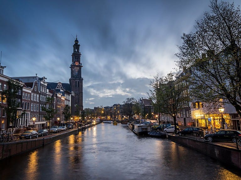 One of Amsterdam's canals runs through the Jordaan neighborhood in Amsterdam at dusk.