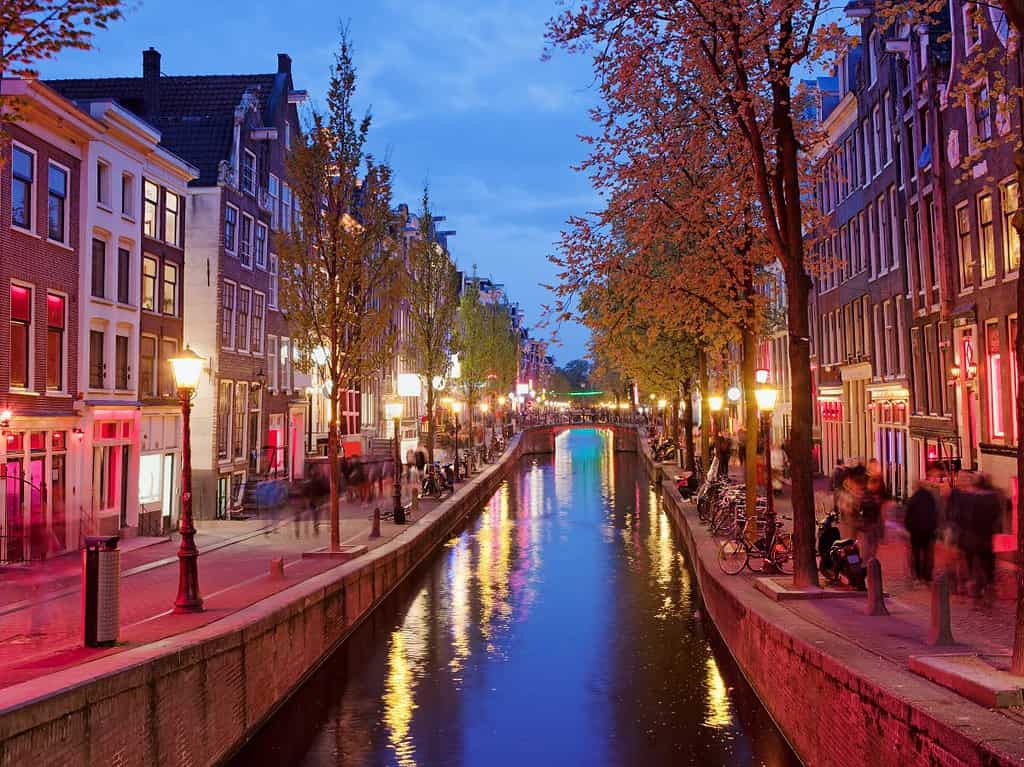 looking down a canal lined with buildings in Amsterdam's red light district.