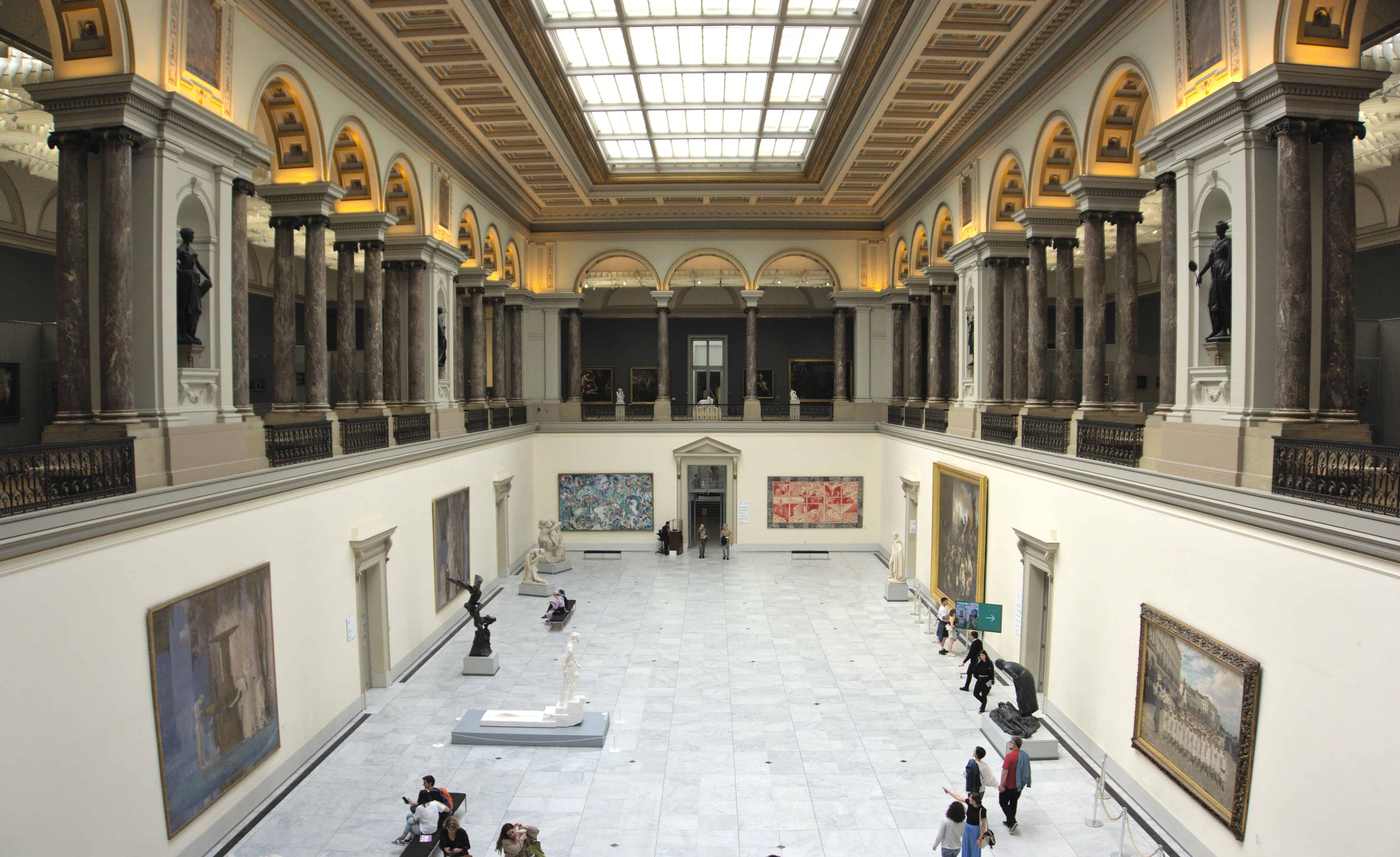 An open two story hall containing art work in the Royal Museum of Fine Arts in Brussels