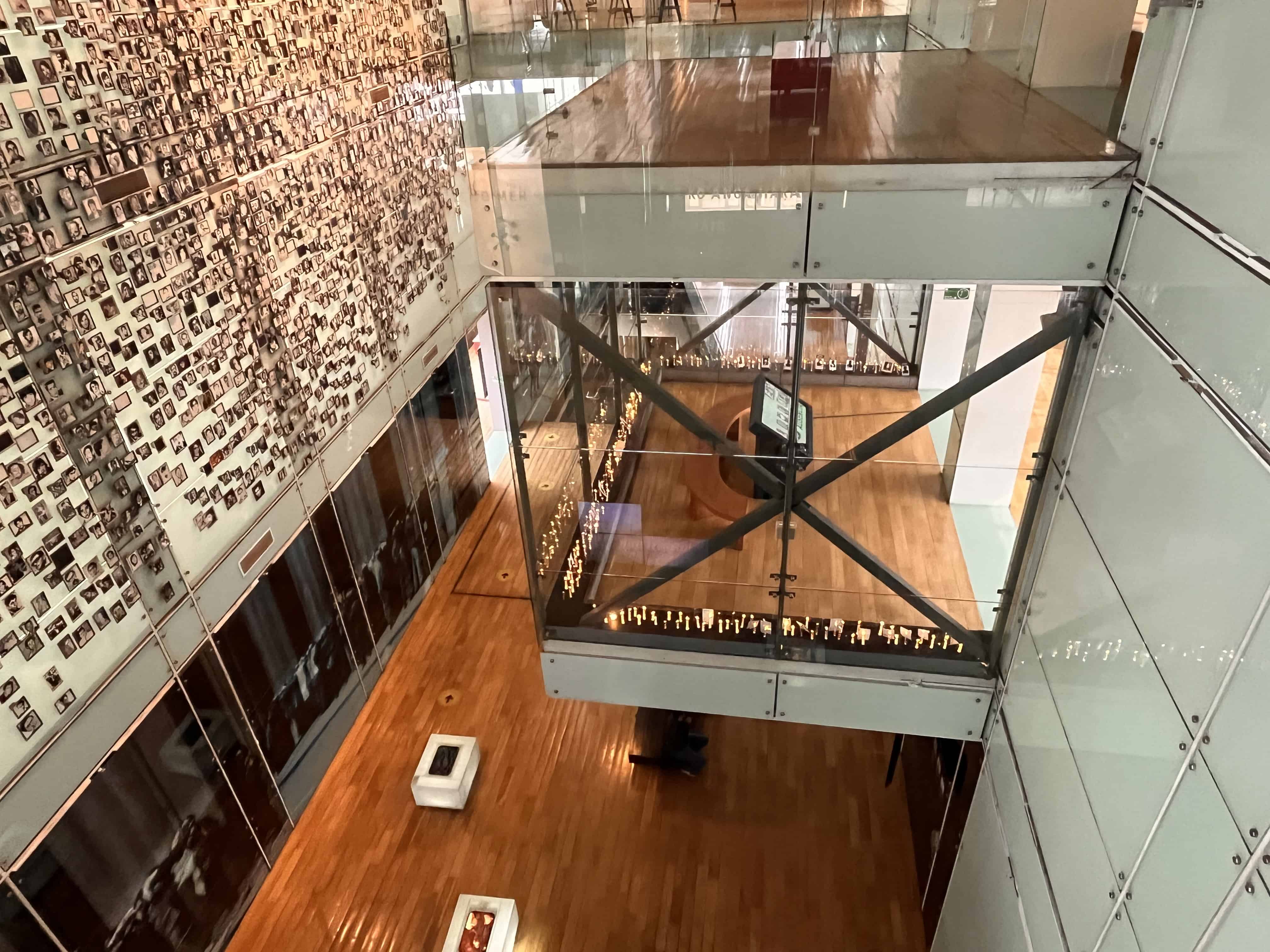 A large wall with hundreds of photos makes up the interior of the museum of memory and human rights in Chile.  It shows the importance of travel to have firsthand learning experiences.