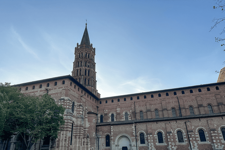 A large brick building with white accents around the windows in France