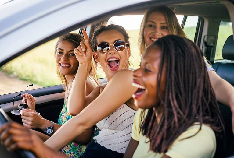 Four women are in a vehicle on an accessible road trip.