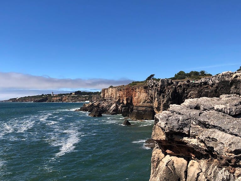 Large rocky cliffs of the Atlantic coastline meet the ocean.