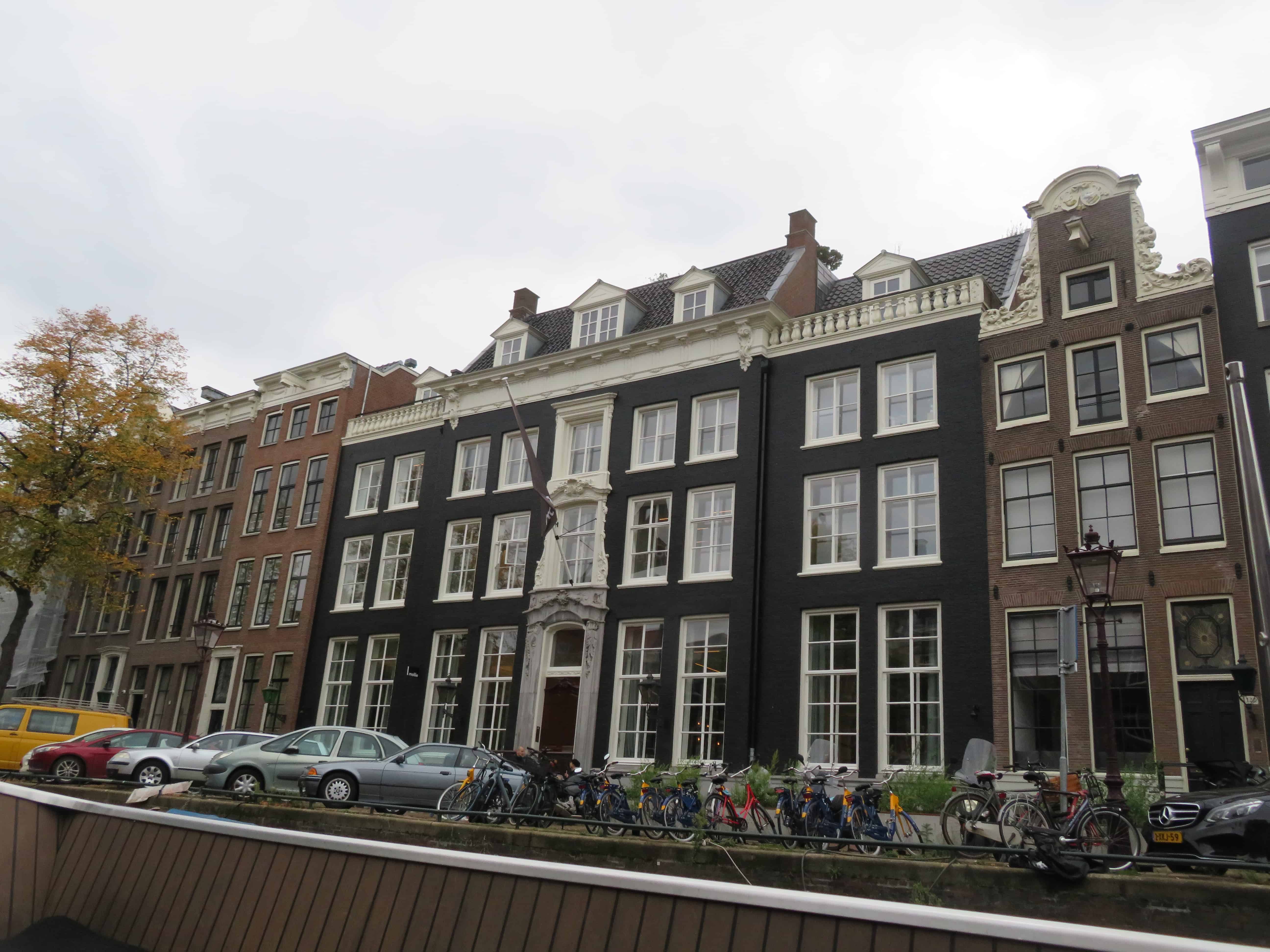 A line of traditional houses in Amsterdam have exterior colors of brown black and red.