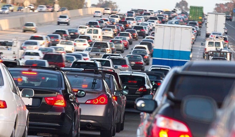 Hundreds of cars are caught in a traffic jam along a freeway