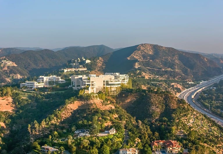 An aerial view of the Getty center sitting on top of a mountain in LA