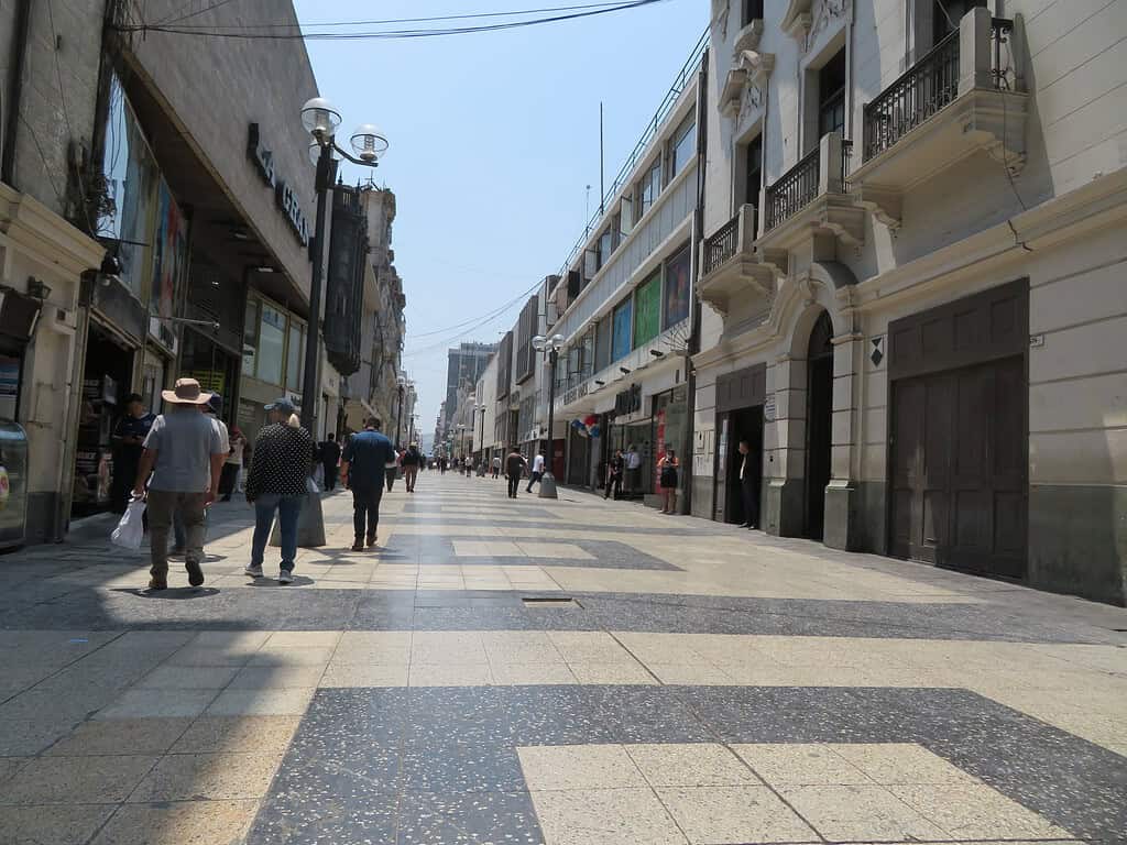 A pedestrian street is tiled and lined with shops in Lima Peru.  It is one of the stops on my 8 day Peru itinerary